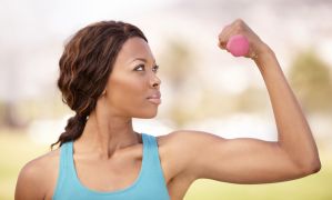 A beautiful african-american woman doing weight training outdoors