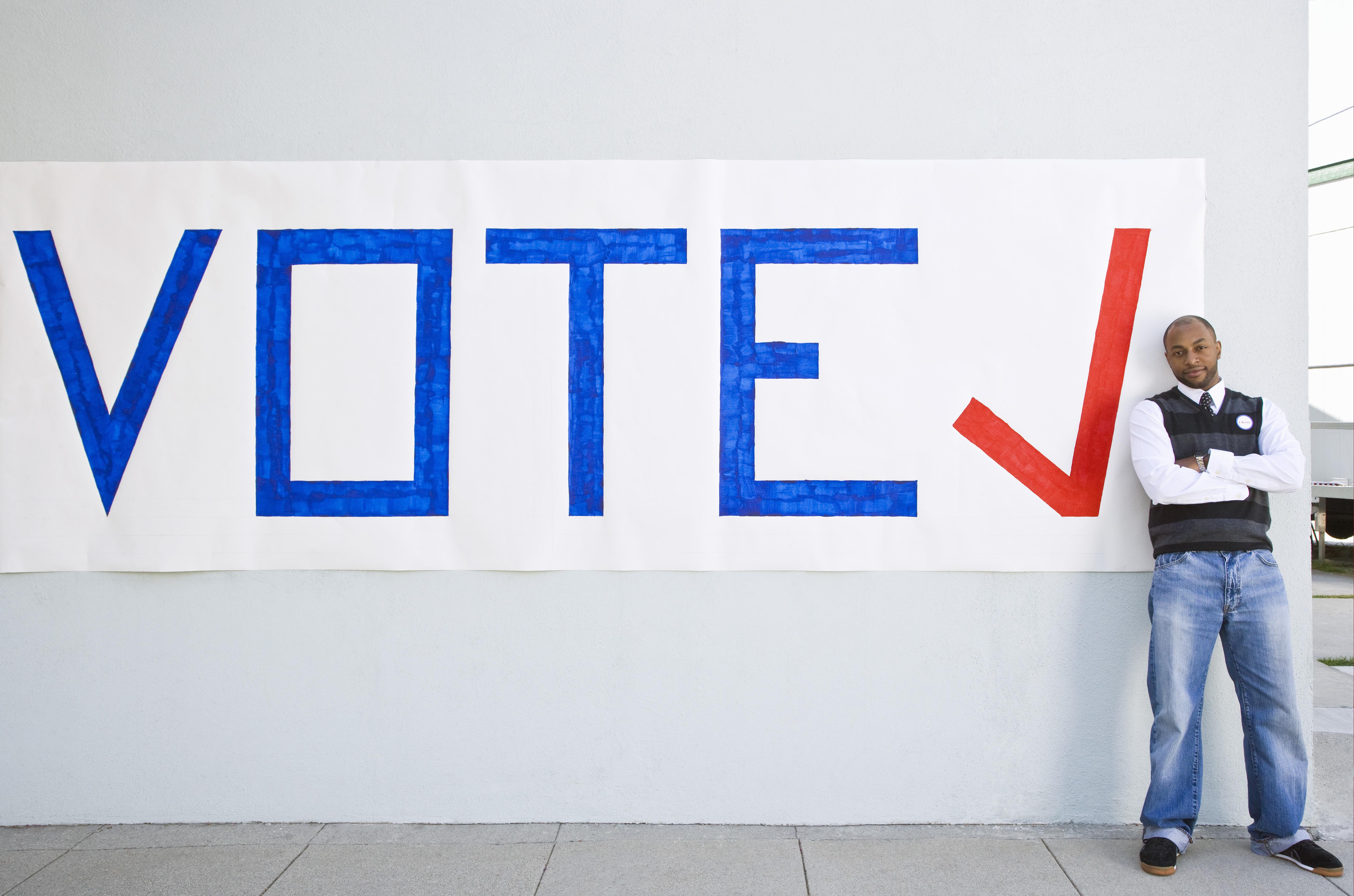 Man standing with vote sign
