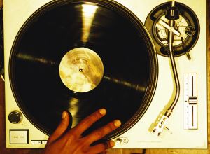 high angle close-up of a hand scratching a vinyl record on a turntable