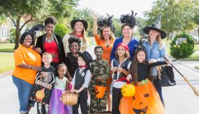 Group of women with children in halloween costumes