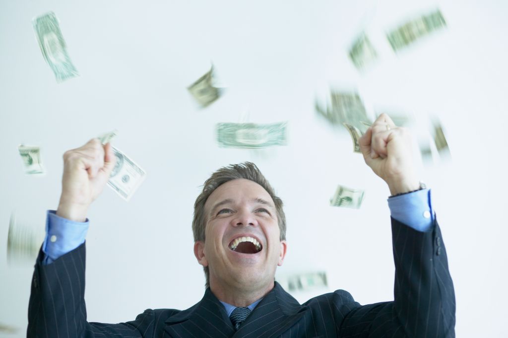 Excited Businessman Throwing Money