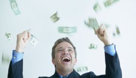 Excited Businessman Throwing Money