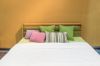 Bedroom interior with bed and colorful pillow of cosy home in modern design. Vintage bedroom.