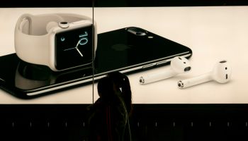 A lightbox shows the new iPhone 7 and wireless earbud in an...