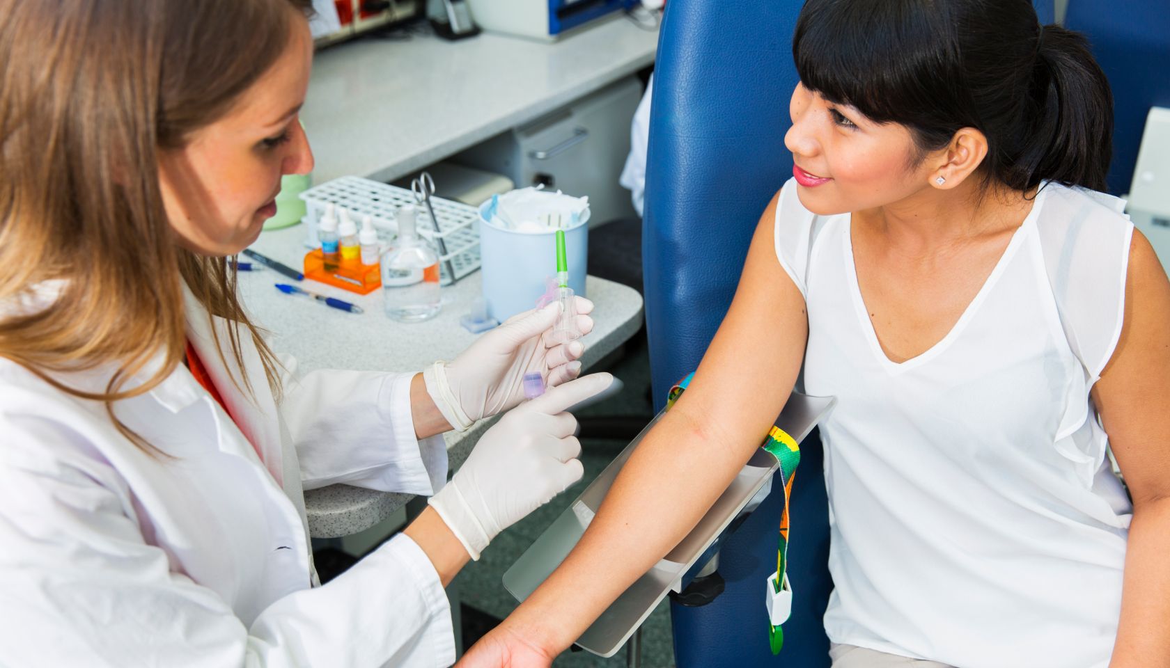 Drawing blood...young doctor prepairing for blood capture
