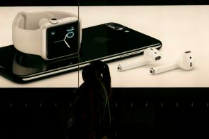 A lightbox shows the new iPhone 7 and wireless earbud in an...