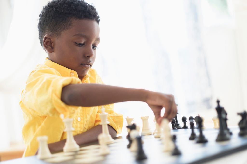 Boy (6-7) playing chess