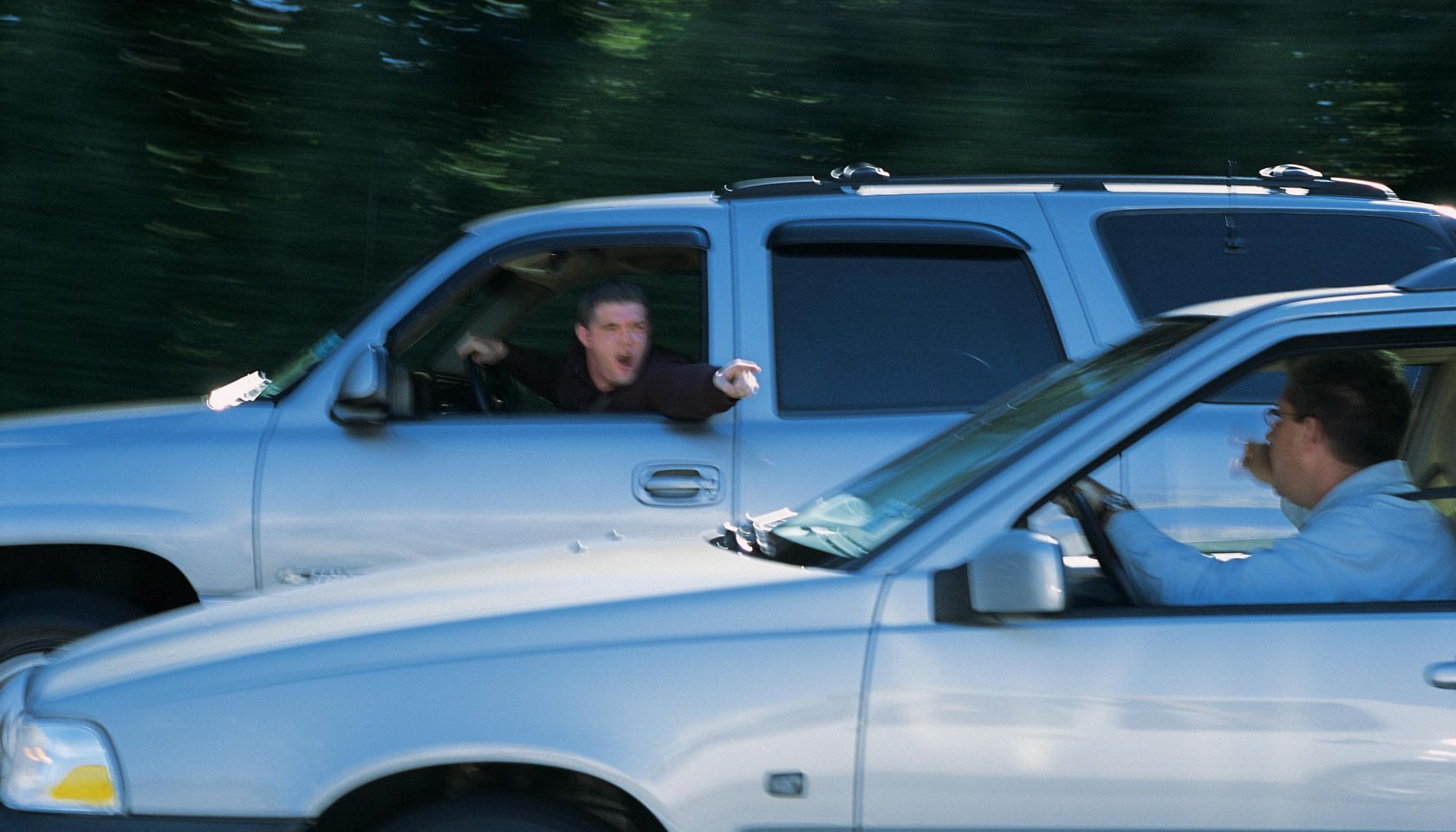 Men arguing with each other from their vehicles while driving