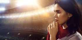 Sport fans: A girl praying