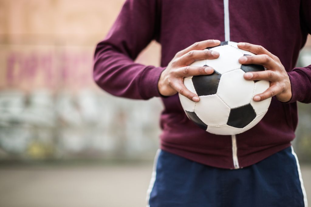 Soccer Player Holding Vintage Soccer Ball