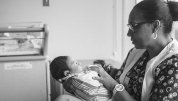 Nurse Holding Newborn Baby At Hospital