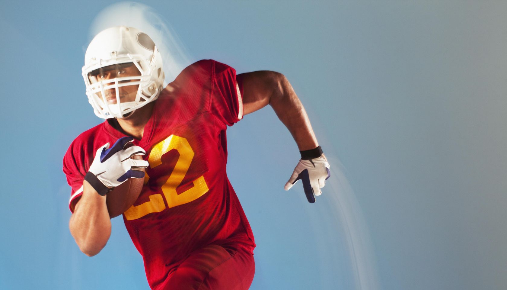 Blurred view of football player running with ball