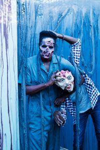 Zombies and monsters in halloween haunted house