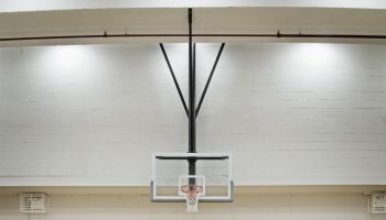 A basketball sits on the free throw line.