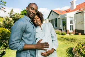 Loving man with pregnant woman in yard