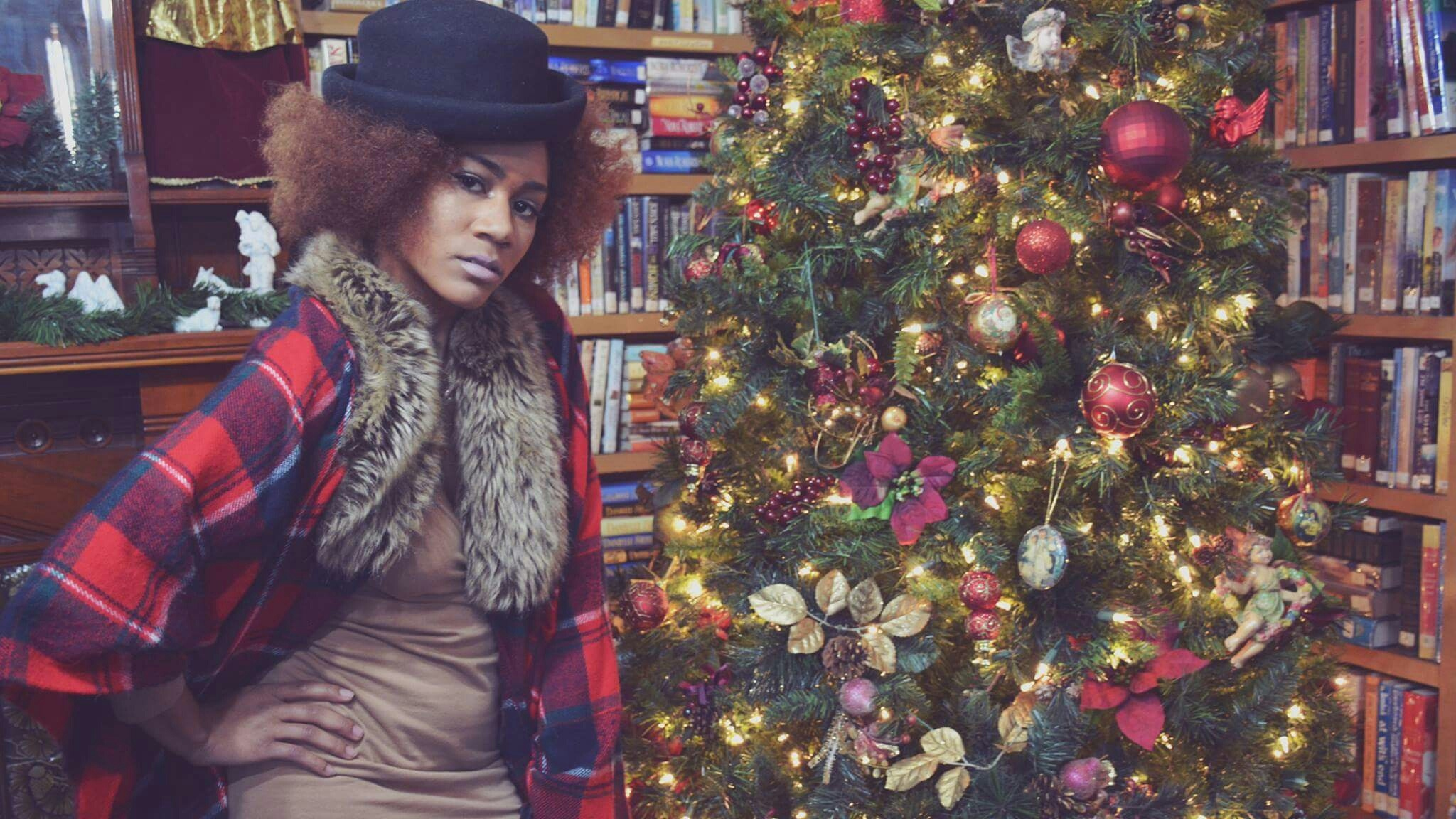Portrait Of Woman Standing By Christmas Tree
