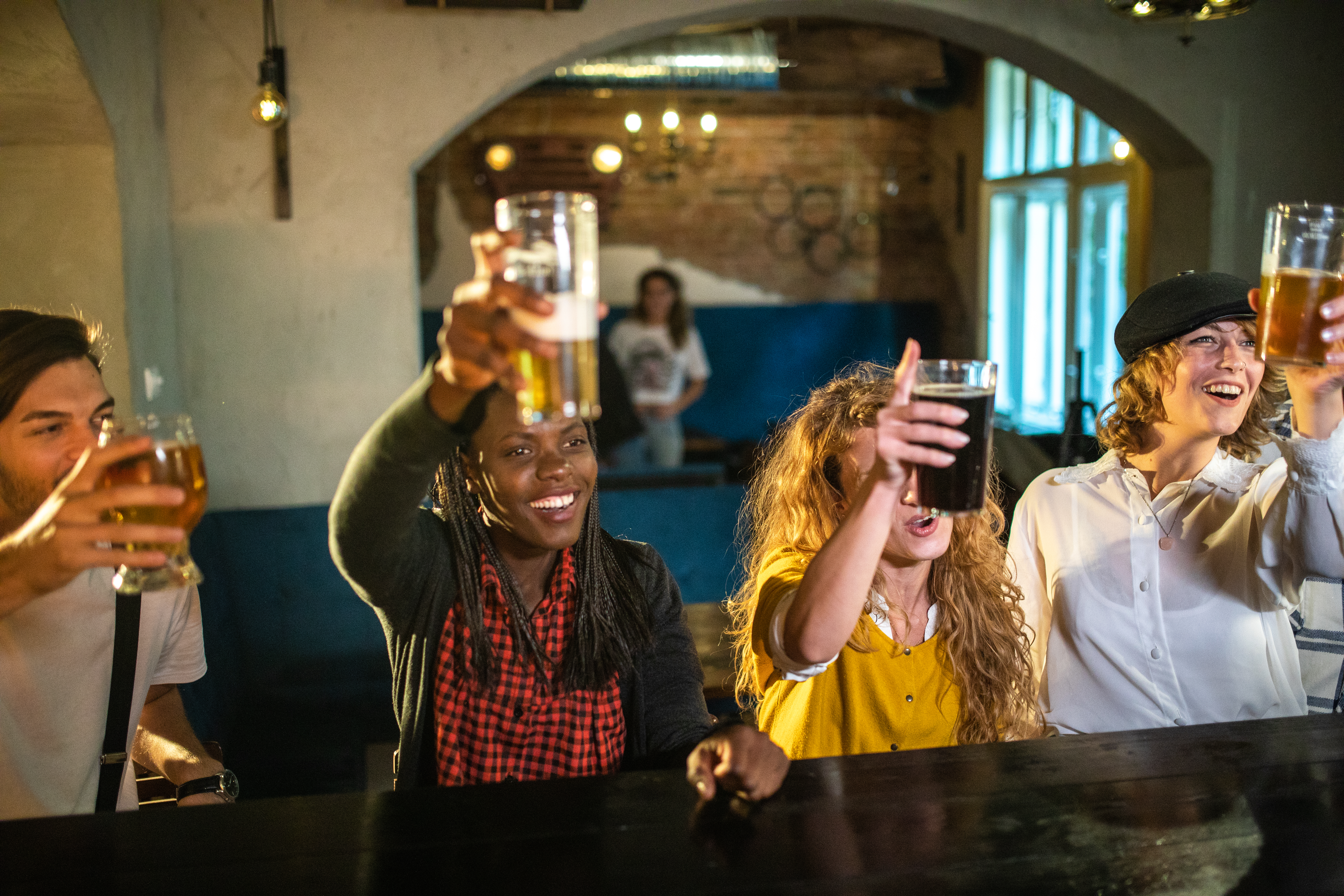 Happy Friends Toasting At Pub