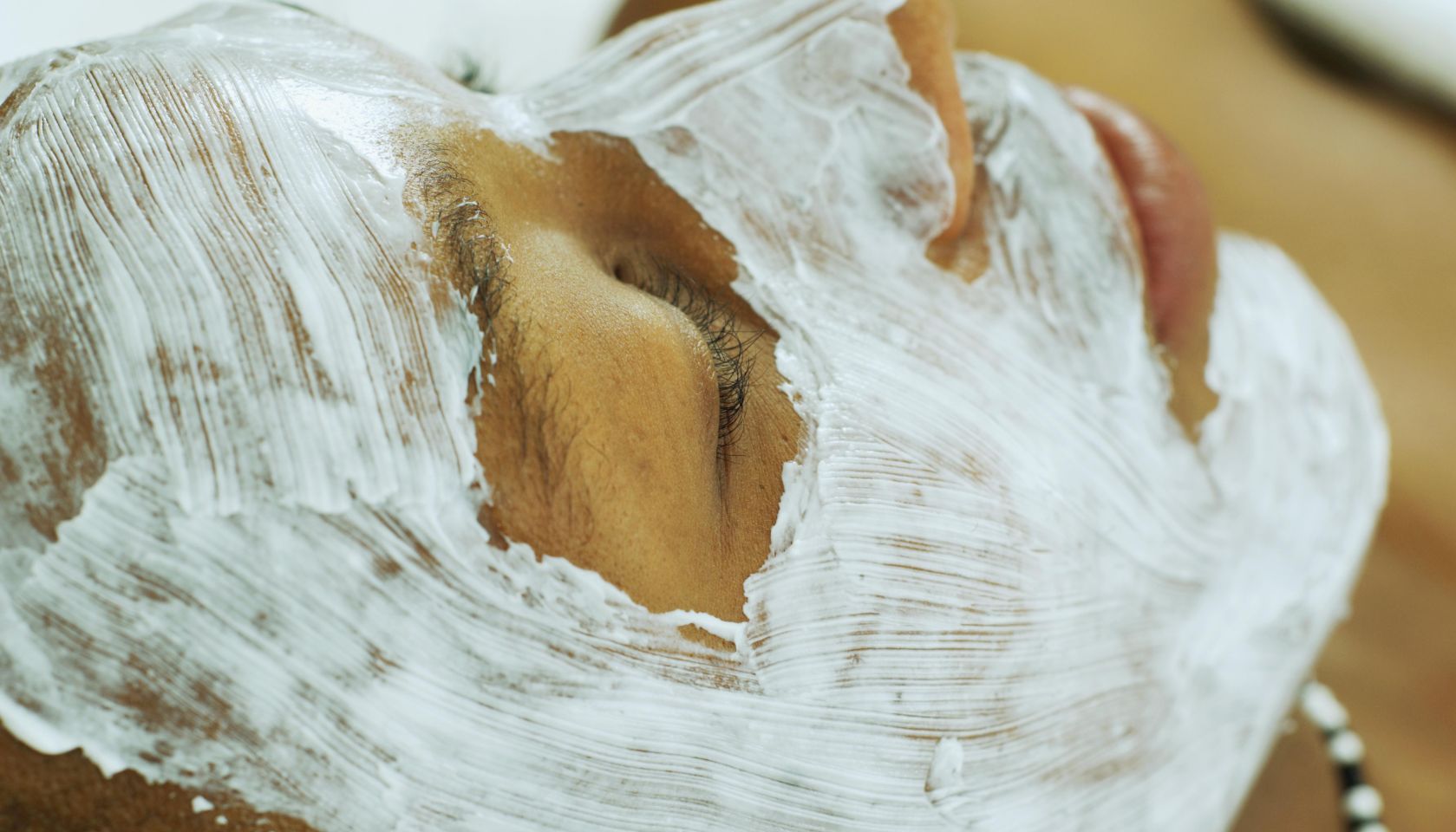 African man receiving spa facial treatment