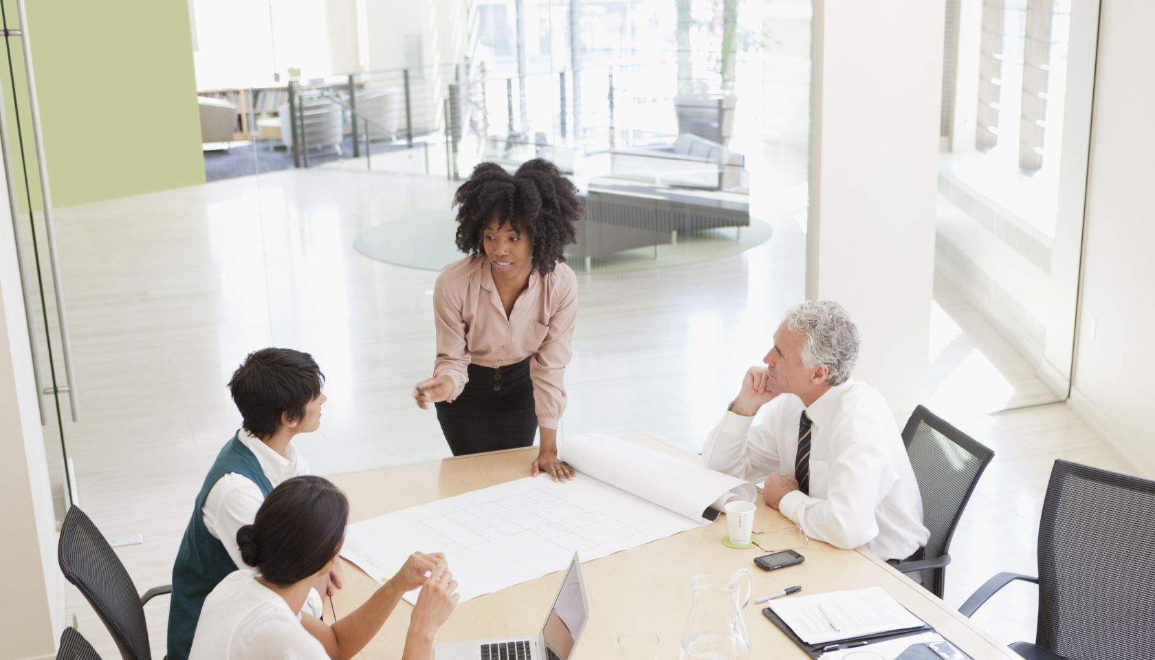 Project discussions amongst employees in boardroom