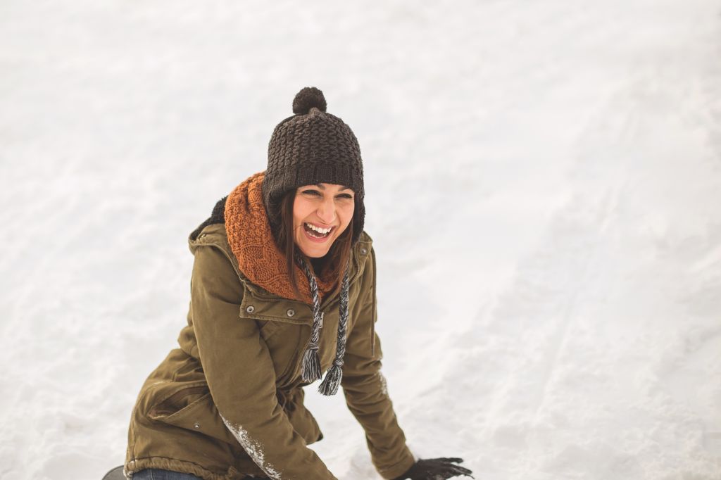 Young woman laughing on snow