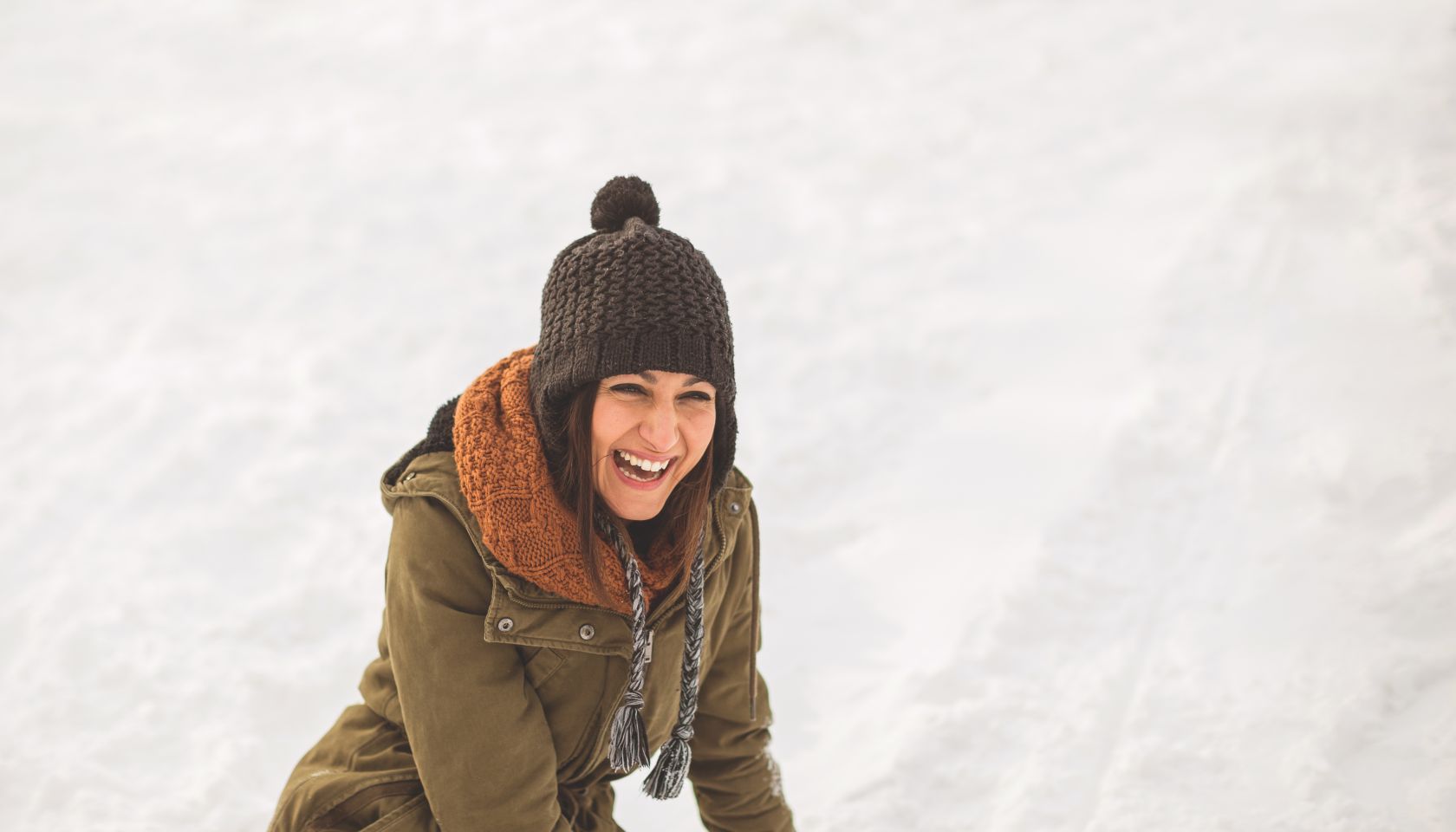Young woman laughing on snow