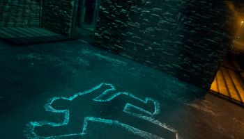 Chalk outline of body of victim on pavement