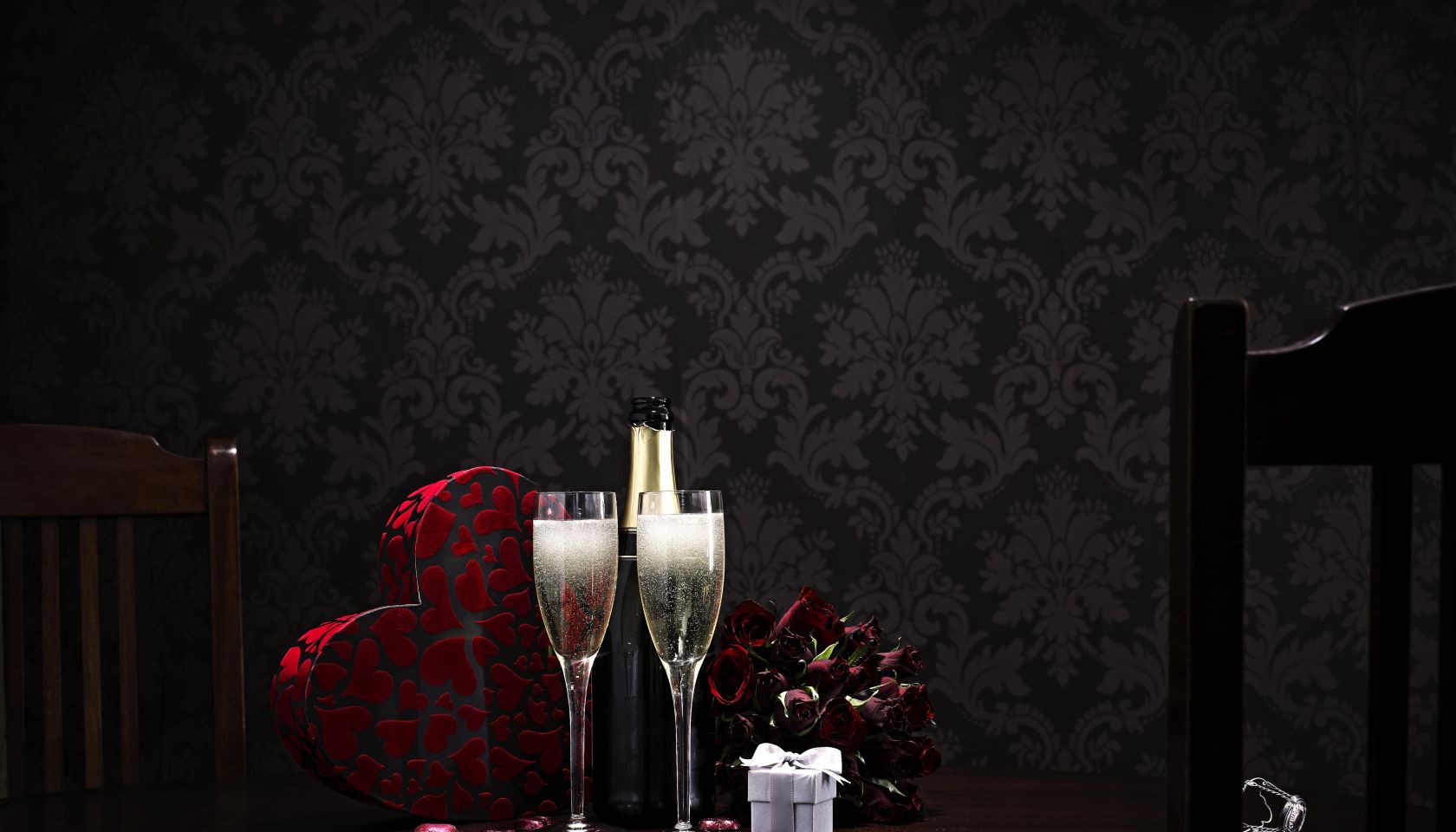 champange and roses and choclates on table