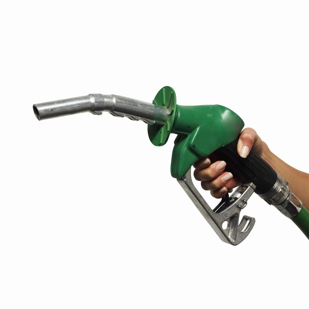 close up view of a hand holding a nozzle for fuel