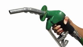 close up view of a hand holding a nozzle for fuel
