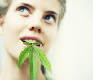 women with hemp leaf in mouth