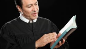 Hispanic pastor reading from Bible
