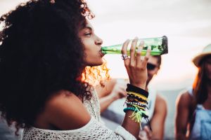 Young woman drinking beer