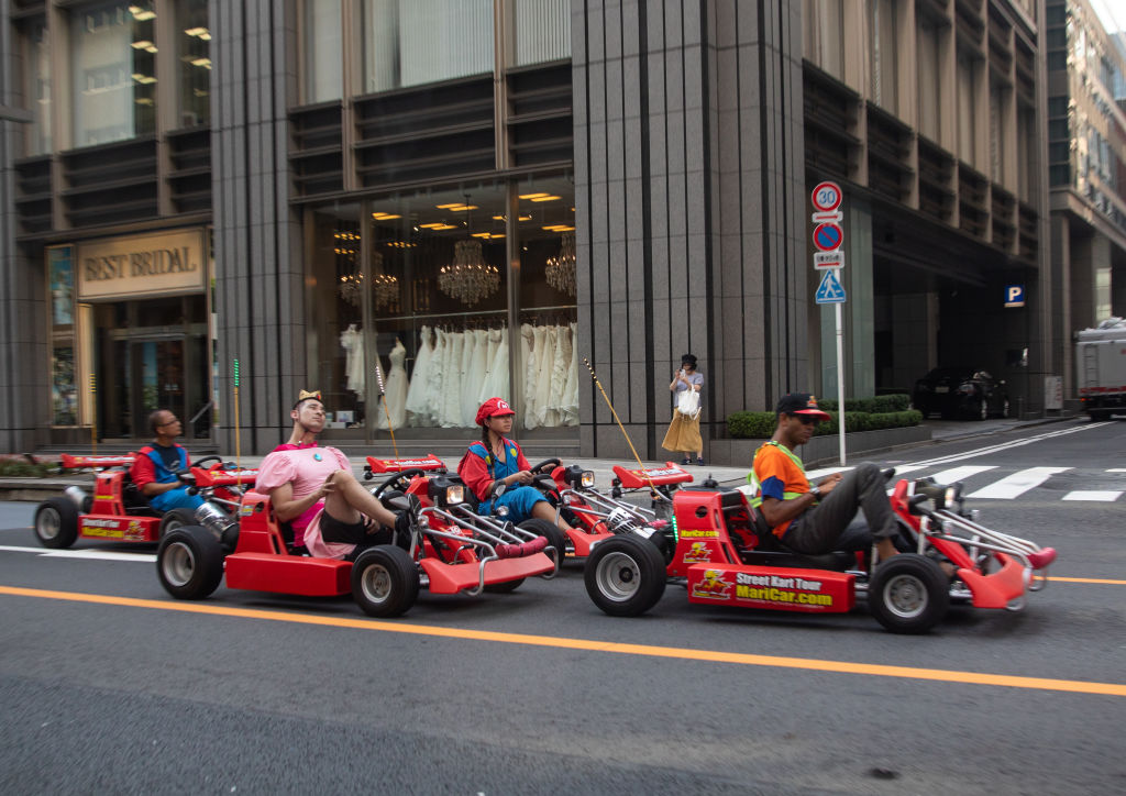 People driving karting cars dressed in super Mario, Kanto region, Tokyo, Japan...