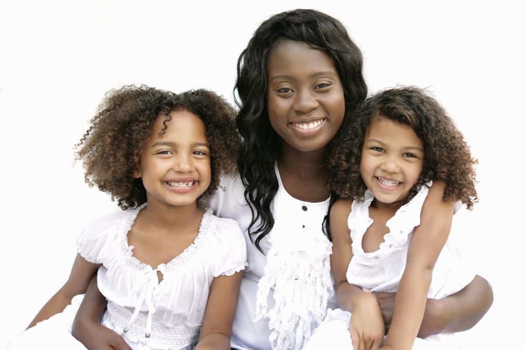 Mother and two daughters smiling together, Pretoria, Gauteng Province, South Africa