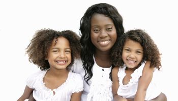 Mother and two daughters smiling together, Pretoria, Gauteng Province, South Africa