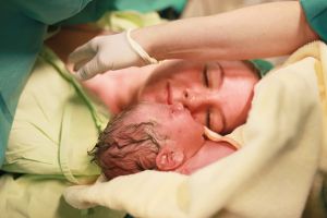 Mother looking at newborn after parturition