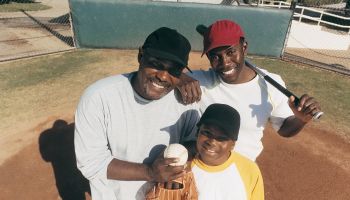 Portrait of a Father Standing With His Two Sons on a Baseball Field