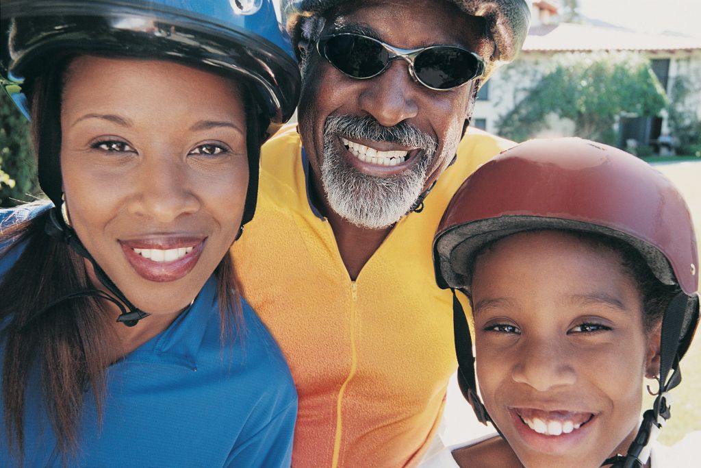 Portrait of Three Members of the Same Family Wearing Cycling Helmets and Jerseys