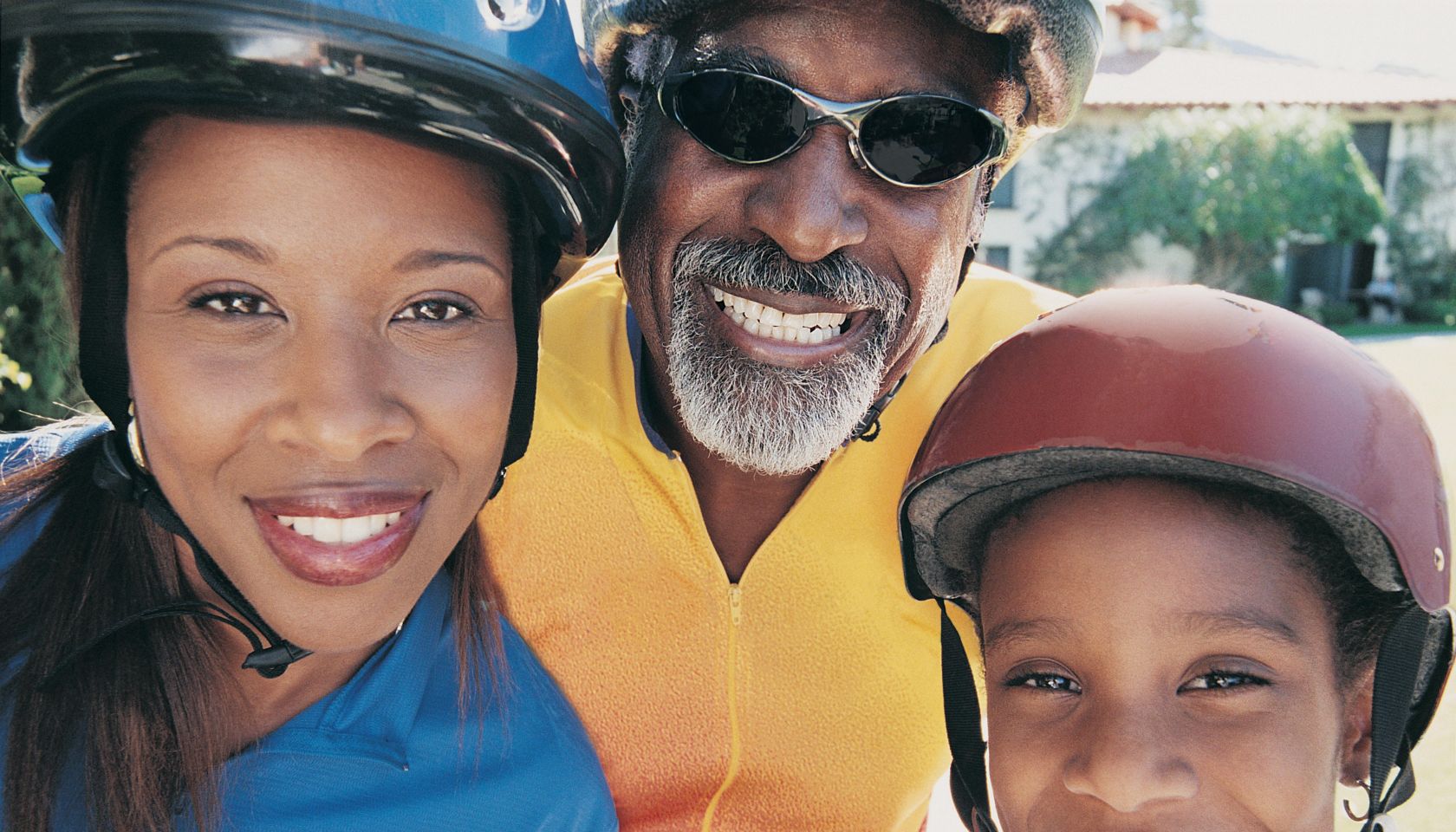 Portrait of Three Members of the Same Family Wearing Cycling Helmets and Jerseys