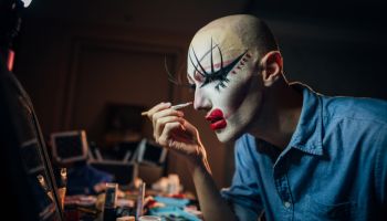 Transsexual man putting make up