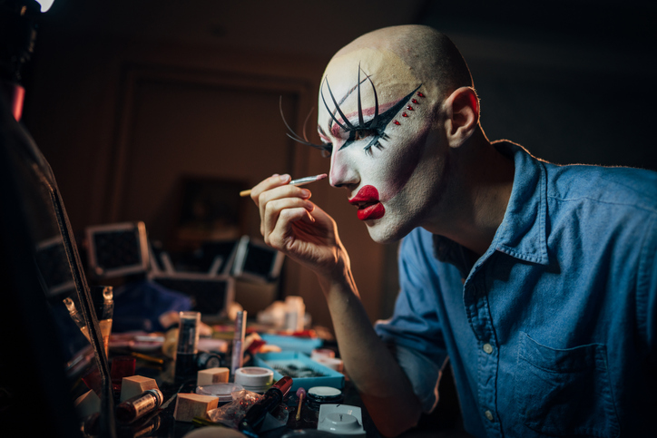 Transsexual man putting make up