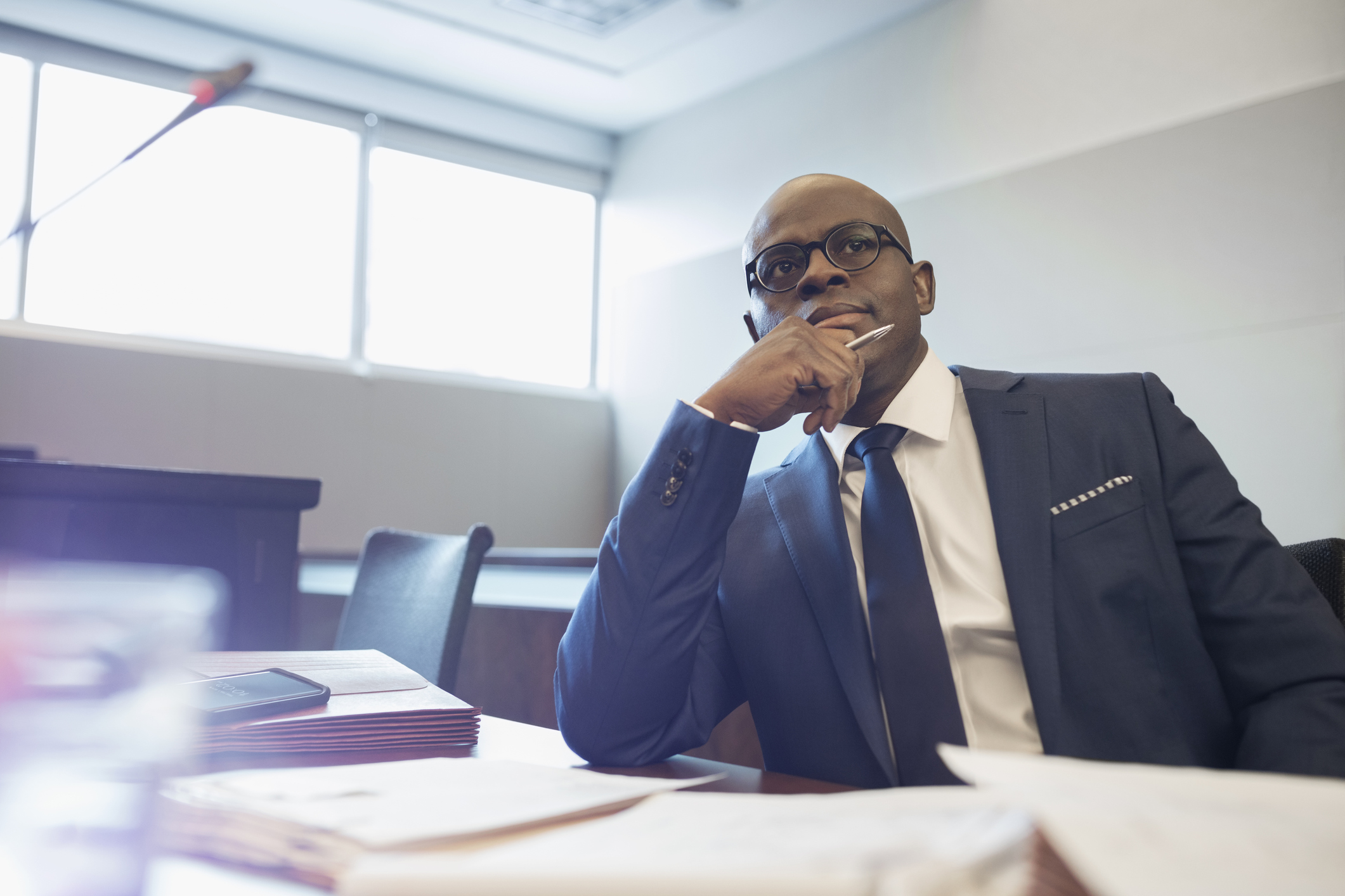 Serious, attentive male prosecutor attorney listening in courtroom