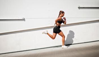 Young sportswoman running outdoors on a sunny day