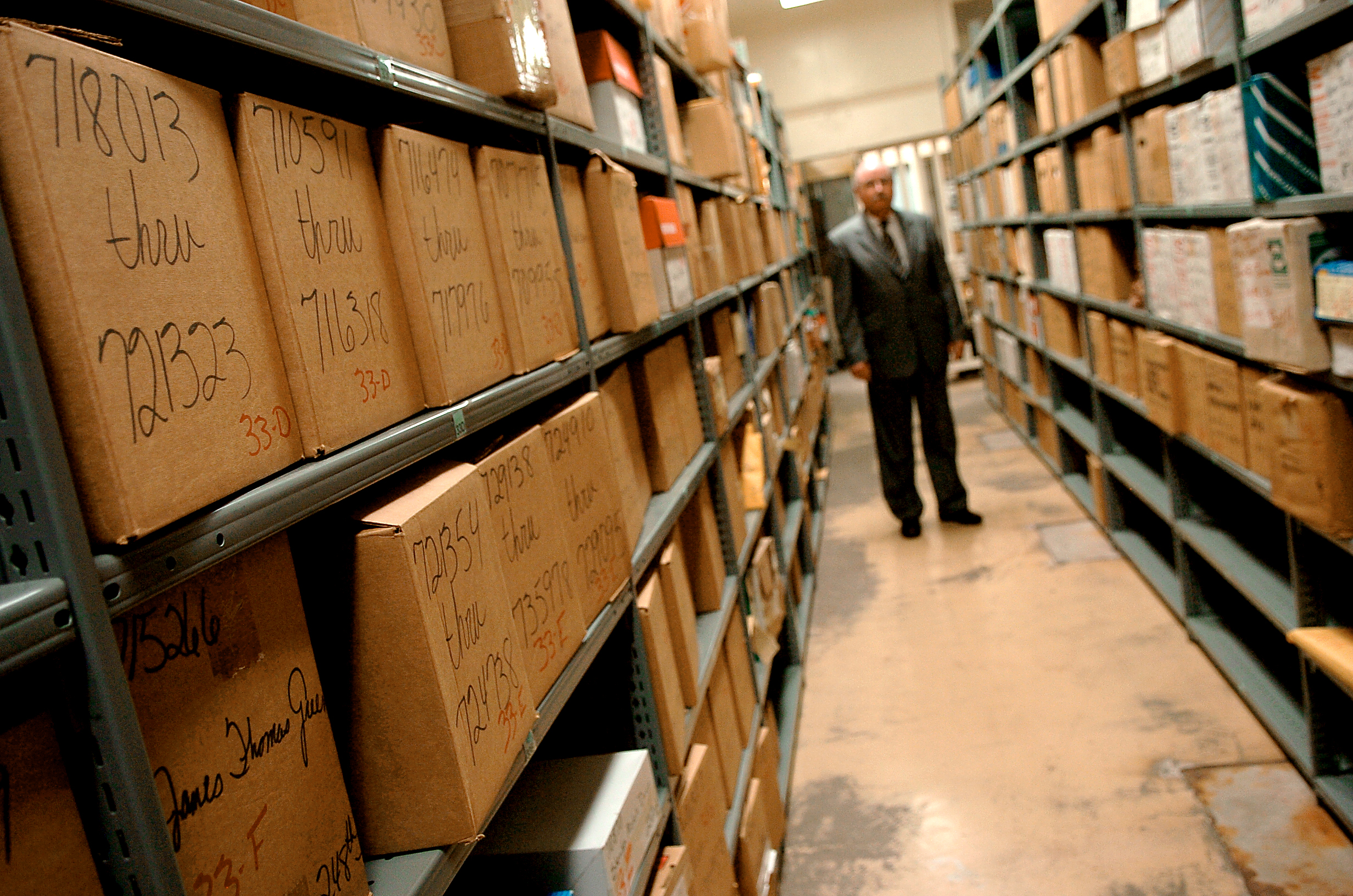 HOUSTON, CO--JANUARY 17, 2007-- Wes McCoy Director of the Criminal Bureau for the Harris County Courthouse, stands amidst shelves and shelves of stored evidence in the courthouse evidence room, which is currently housed inside the cells of an old jai