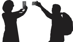 Two People Taking Selfies Silhouettes