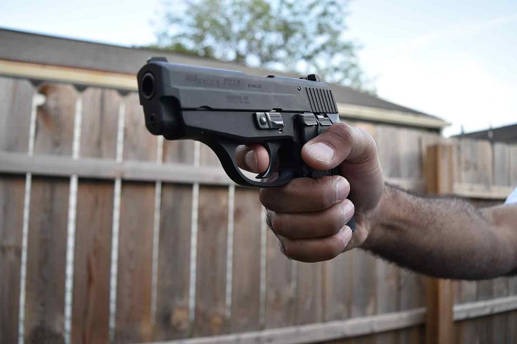 Man holding handgun pistol