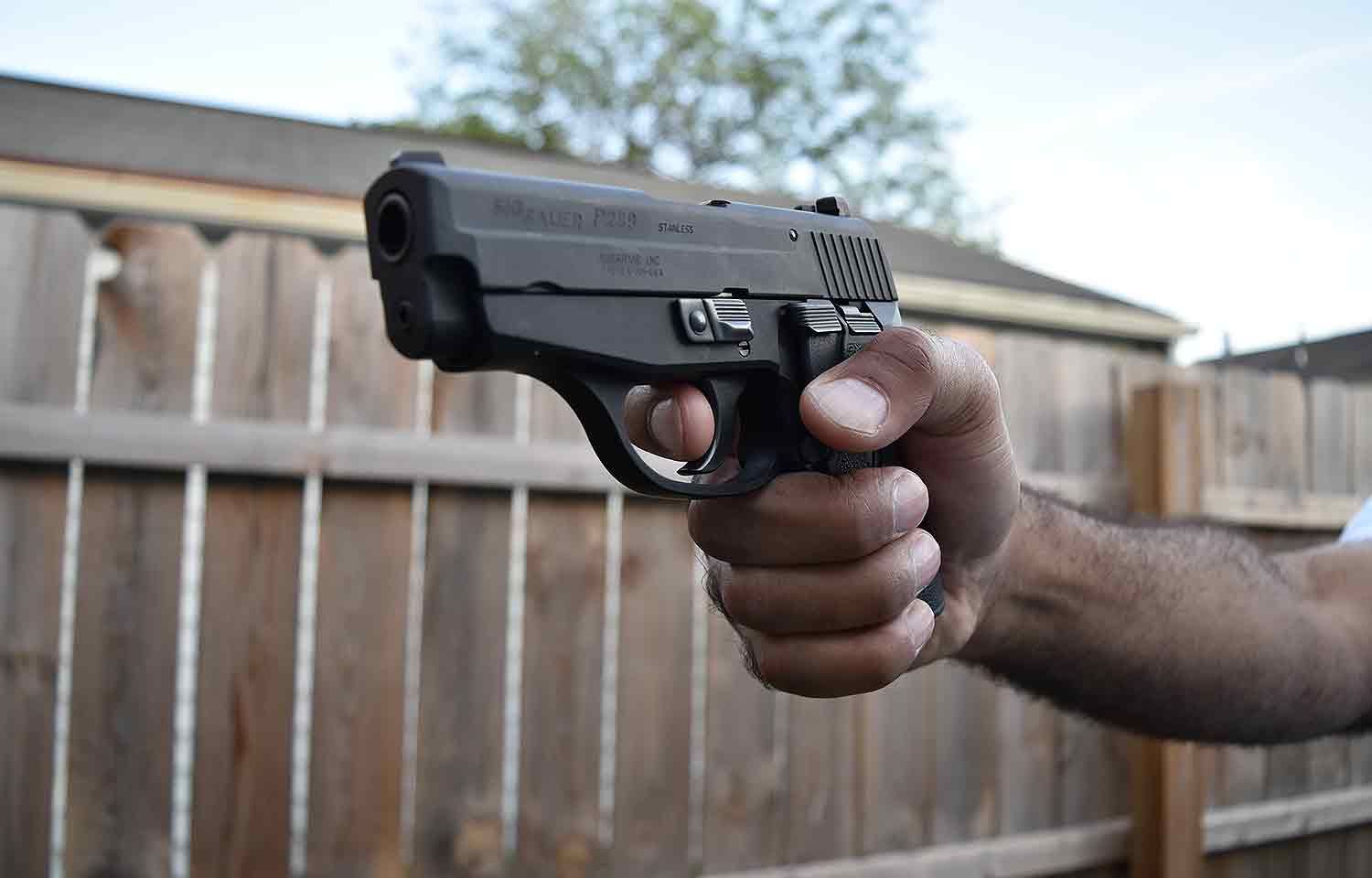 Man holding handgun pistol