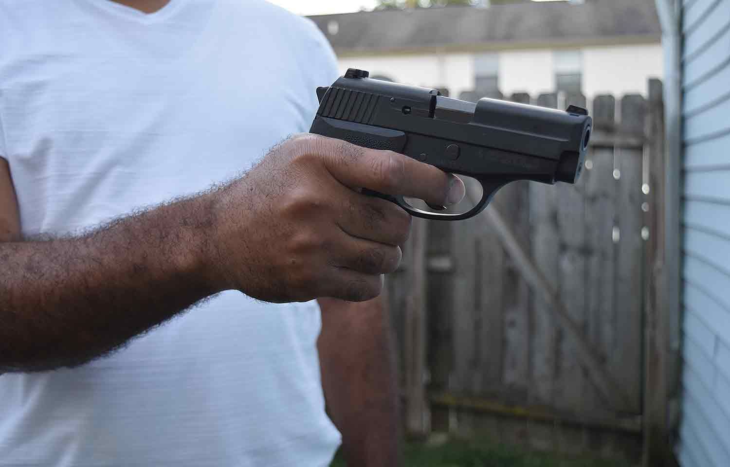 Man holding handgun pistol