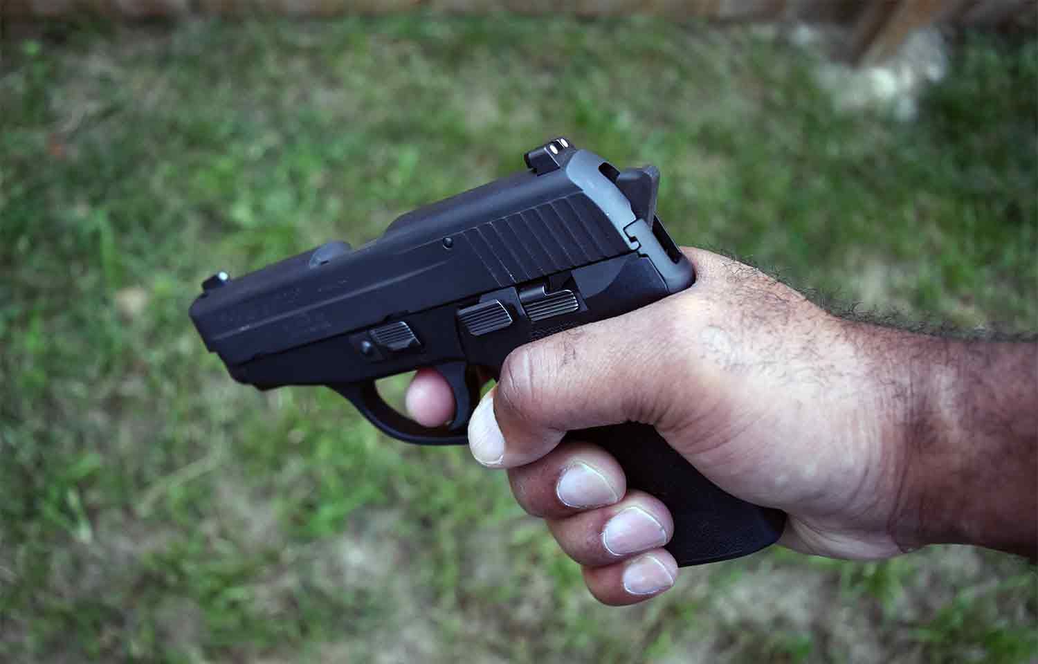 Man holding handgun pistol