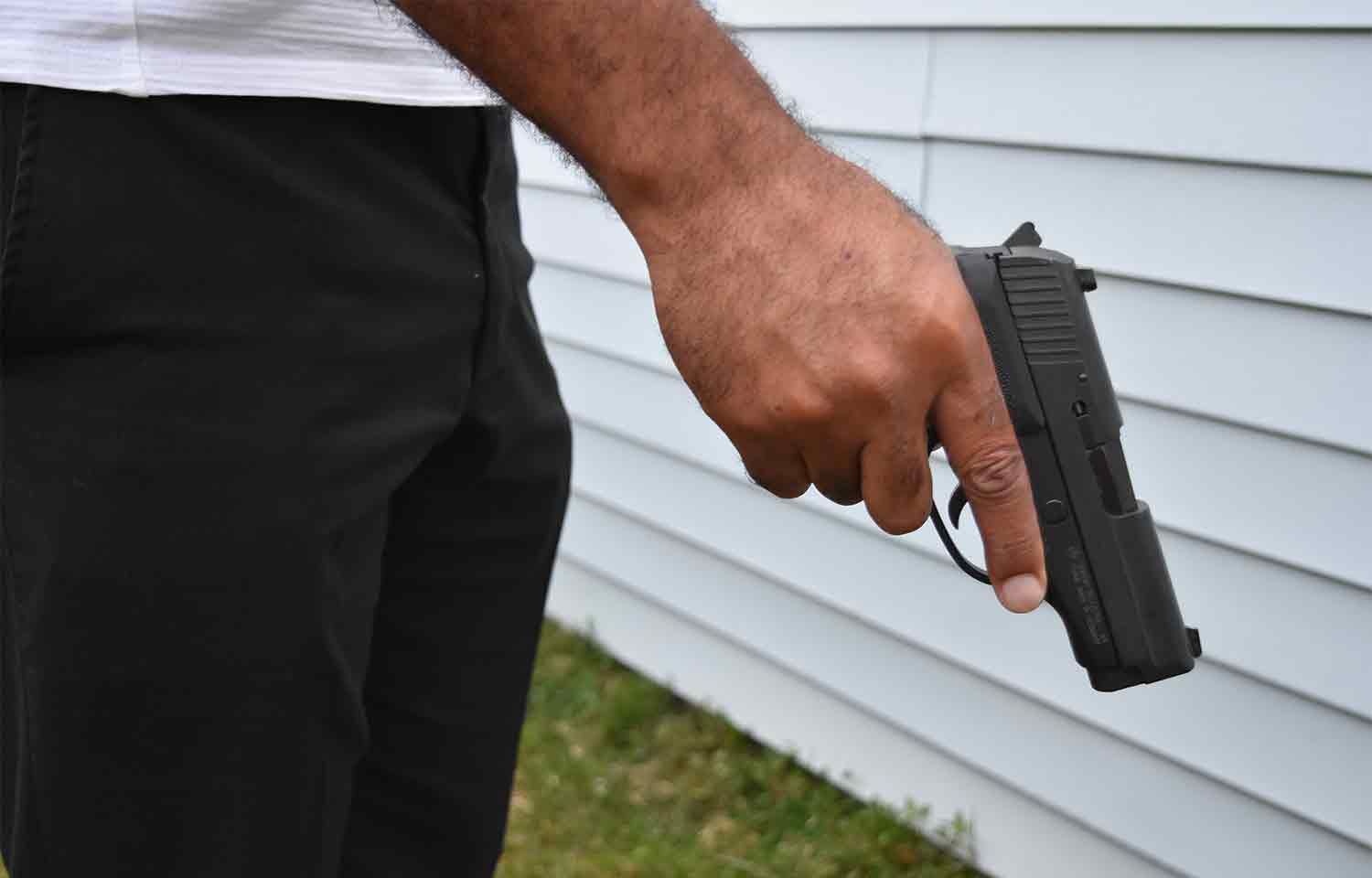 Police Officer holding handgun pistol